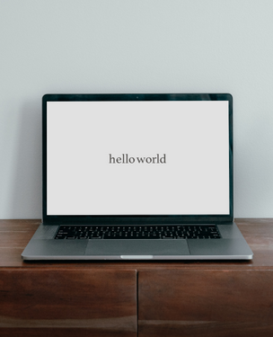 Hello World typed out on laptop screen.