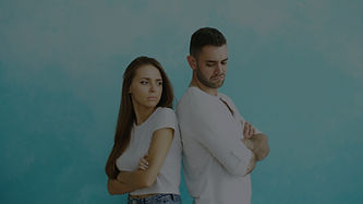 Young couple upset and angry each other standing back to back on blue background_edited.jp