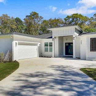 one-story Craftsman style house new construction Freeport Florida. slab grade concrete stem wall wood framed walls roof brick lap siding exterior shingle roof. It has white vinyl impact rated windows, fiberglass impact rated doors, white traditional Wayne Dalton wind rated garage door. Custom wood Bahama shutters front house. Engineered hardwood flooring tile all bathrooms Stainless steel appliances to go white shaker cabinets granite countertops at kitchen quartz countertops at all baths. closets have custom framed shelving systems. All porches have slip resistant tile tongue groove pine ceilings. oversized garage roomy offers parking for two full size cars one golf cart. tankless water heater recirculating pump included at garage exterior wall. HVAC system is two variable speed air handlers paired 16 SEER heat pumps. back porch leads to an enclosed swimming pool. yard landscaped Bermuda sod, palm trees tropical grasses together irrigation well system.