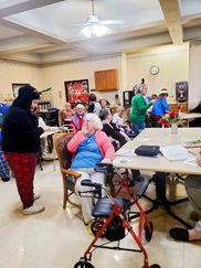 Students help CWF members pass out cookies to residents at Indian Lake Rehab