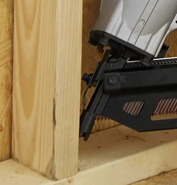 Framing nailer attaching a stud