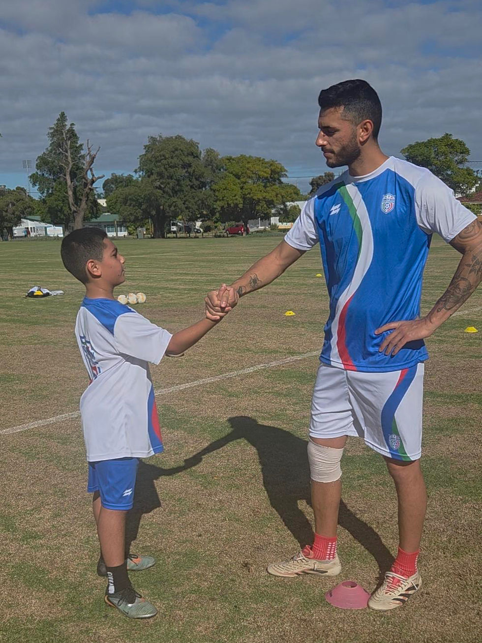 soccer coach and student shaking hands
