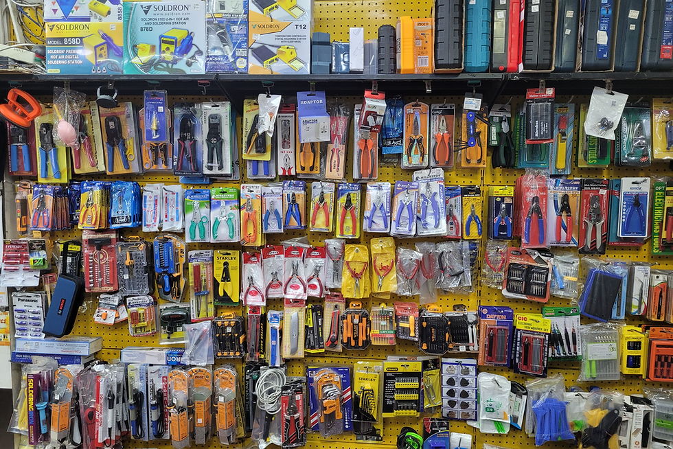 Eye-level view of shelves stocked with various power tools in a hardware store