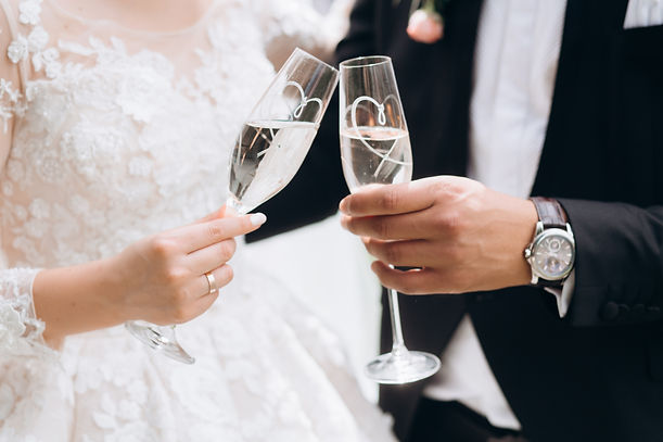 groom-with-bride-are-knocking-glasses-with-champagne.jpg
