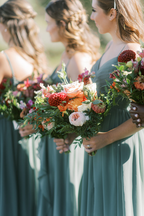 Bridesmaids at wedding wearing eucalyptus Azizie dresses.