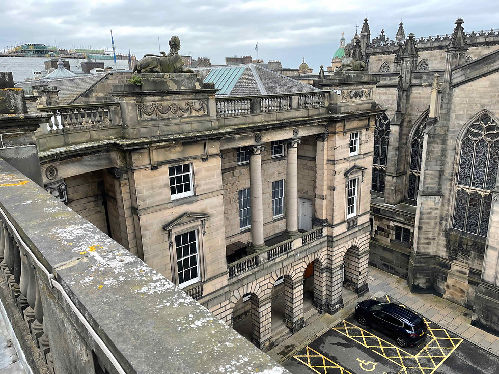 The Reid facade covering the old Scottish Parliament. The original entrance was at ground level below the left hand sphinx. You can clearly see that the central windows are fake.