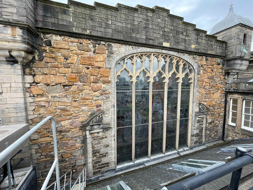 The south end of Parliament Hall. The original 17th Century windows can be seen on either side of the massive stained glass window dating from 1868.