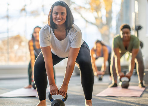 Menopause exercise program focused on strength – woman doing a kettlebell squat workout