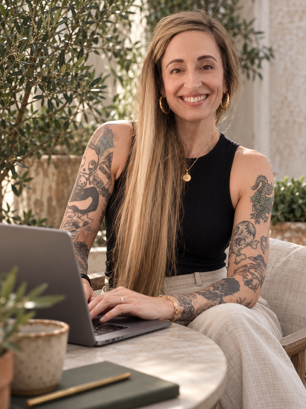 Lola Wilder-Thorne, WILDE Studio website designer in Melbourne, Australia, sitting at her desk with a laptop