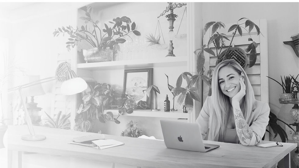 Small Business Website Designer - Strategic branding and website design by Hey! It's Lola featuring Lola Wilder-Thorne sitting at a desk working