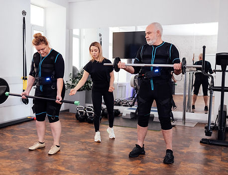 group of adults doing bicep curls with barbells – contact us to get started