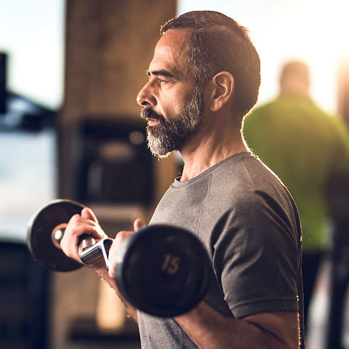 Fit over 40 male client doing a bicep curl