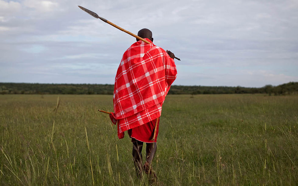 A Maasai Warrior wearing a Masai shuka blanket and African spear