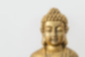Generic golden statue of Buddha on white