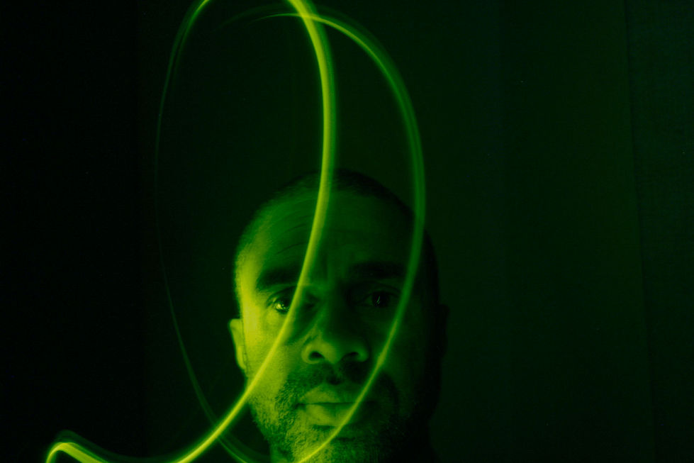 A striking green light in dark photography brings a unique, captivating atmosphere by piercing the darkness with a vivid, often surreal glow.
