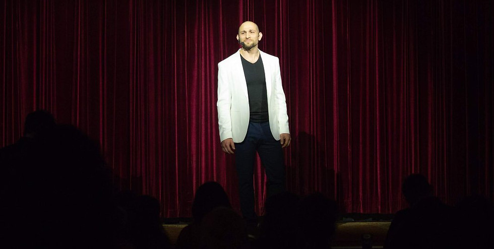 Nader Eid speaking at an event in Toronto, Ontario, with the audience captivated