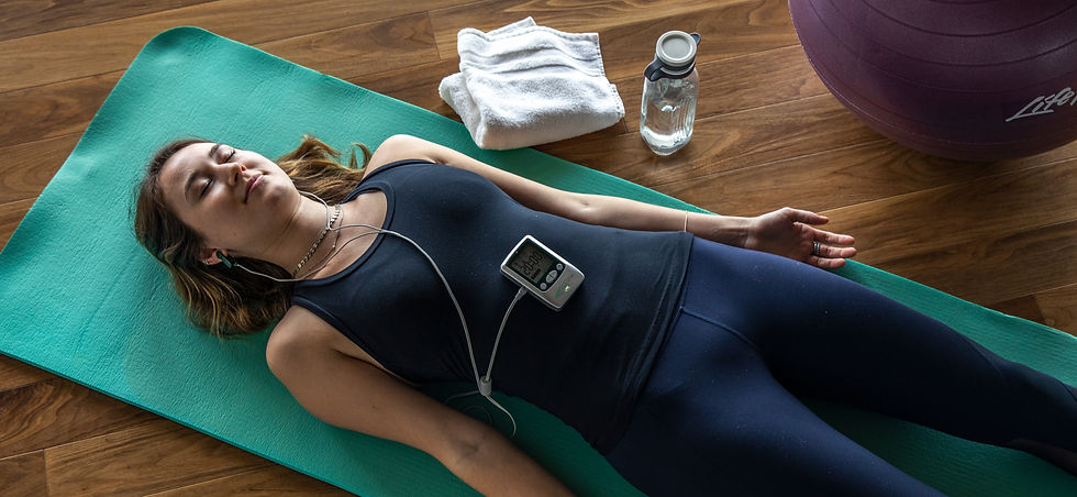 women doing alpha stim therapy on yoga mat