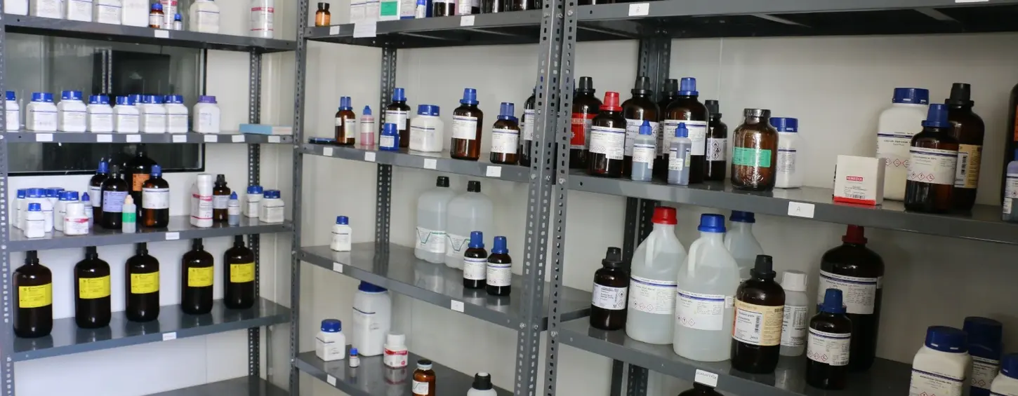 Chemical bottles displayed on shelves. Analytical Laboratory Hetero, Infrastructure, storage context.