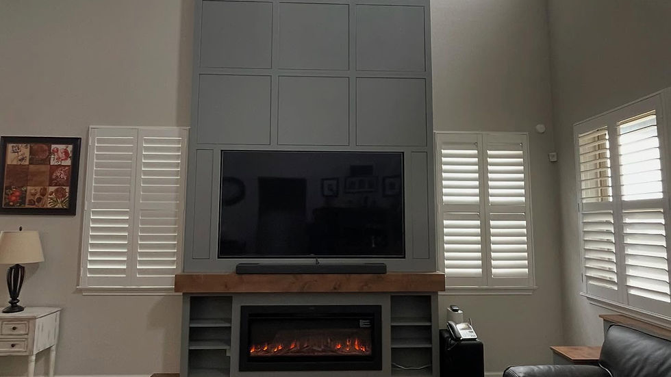 Wide angle view of a cozy living room featuring custom cabinets and an electric fireplace