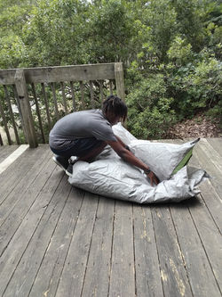 Youth breaking down tent