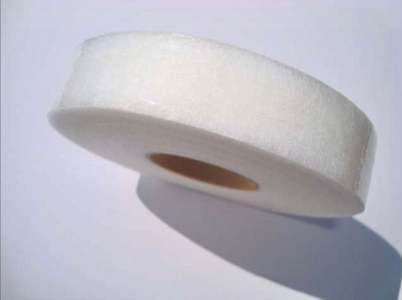 10m length of 25mm wide iron on hemming web, white