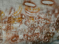 a photo of 'red hands cave' in blue mountains national park, an ancient aboriginal art piece which features handprints on a rock wall