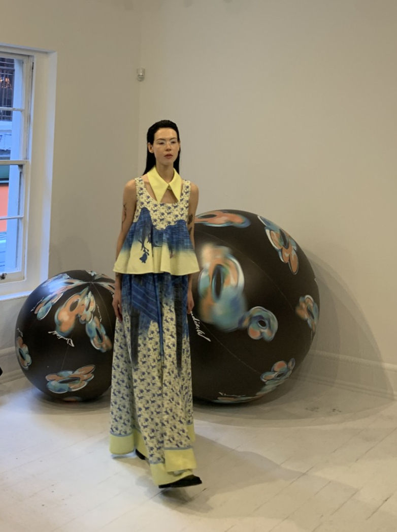 Female Model in cream and blue two piece set by Claudia Wang