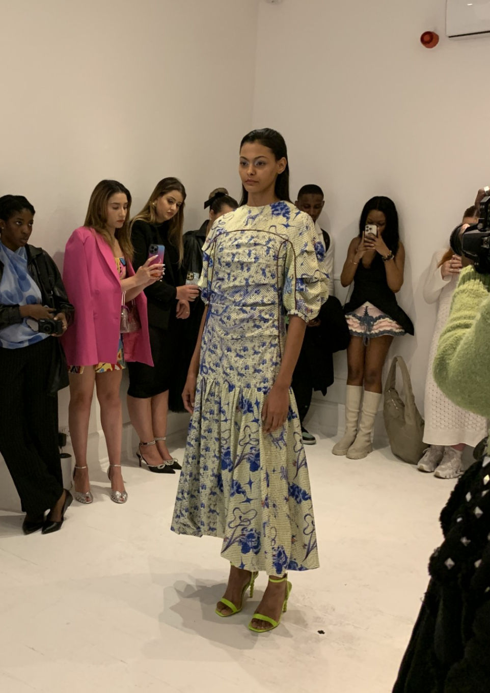 Female model in cream and blue Claudia Wang dress