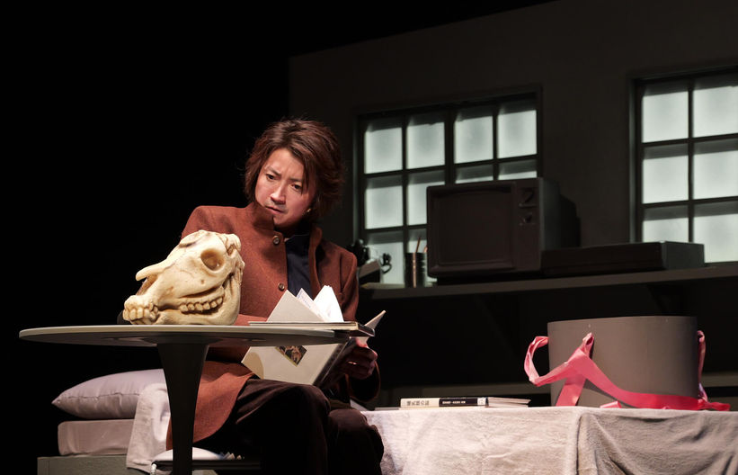 Character staring at animal skull