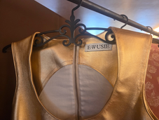 a E.WUSIE SS27 golden dress with the label's tag