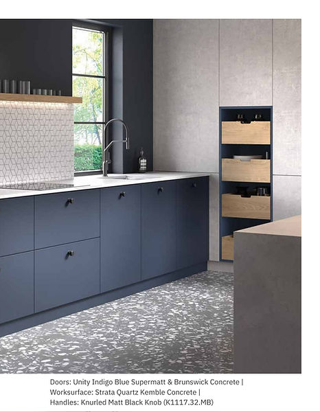 Modern blue kitchen with drawers and concrete backsplash