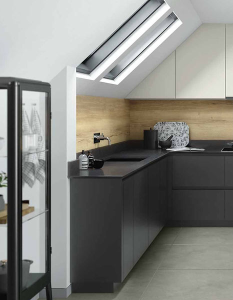 Modern kitchen design with dark cabinetry and skylights