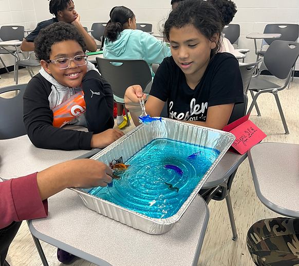 Two young children working with ocean science experimenting.