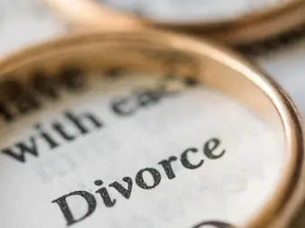 Divorce financial planning Sydney - magnifying glass examining divorce document and settlement costs