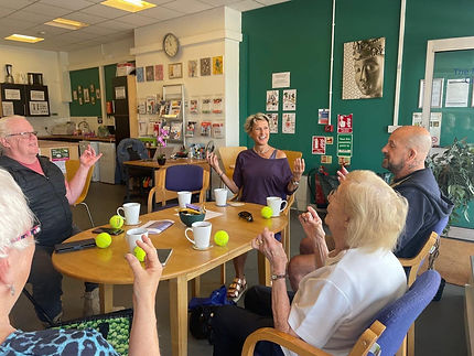 An image of Jo Taylor from Mulberry Wellness sitting around a table with guests of all ages and abilities 