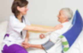 Woman helping elderly woman