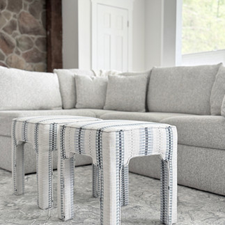 Cozy ohio family room with blue striped ottomans and neutral sofa