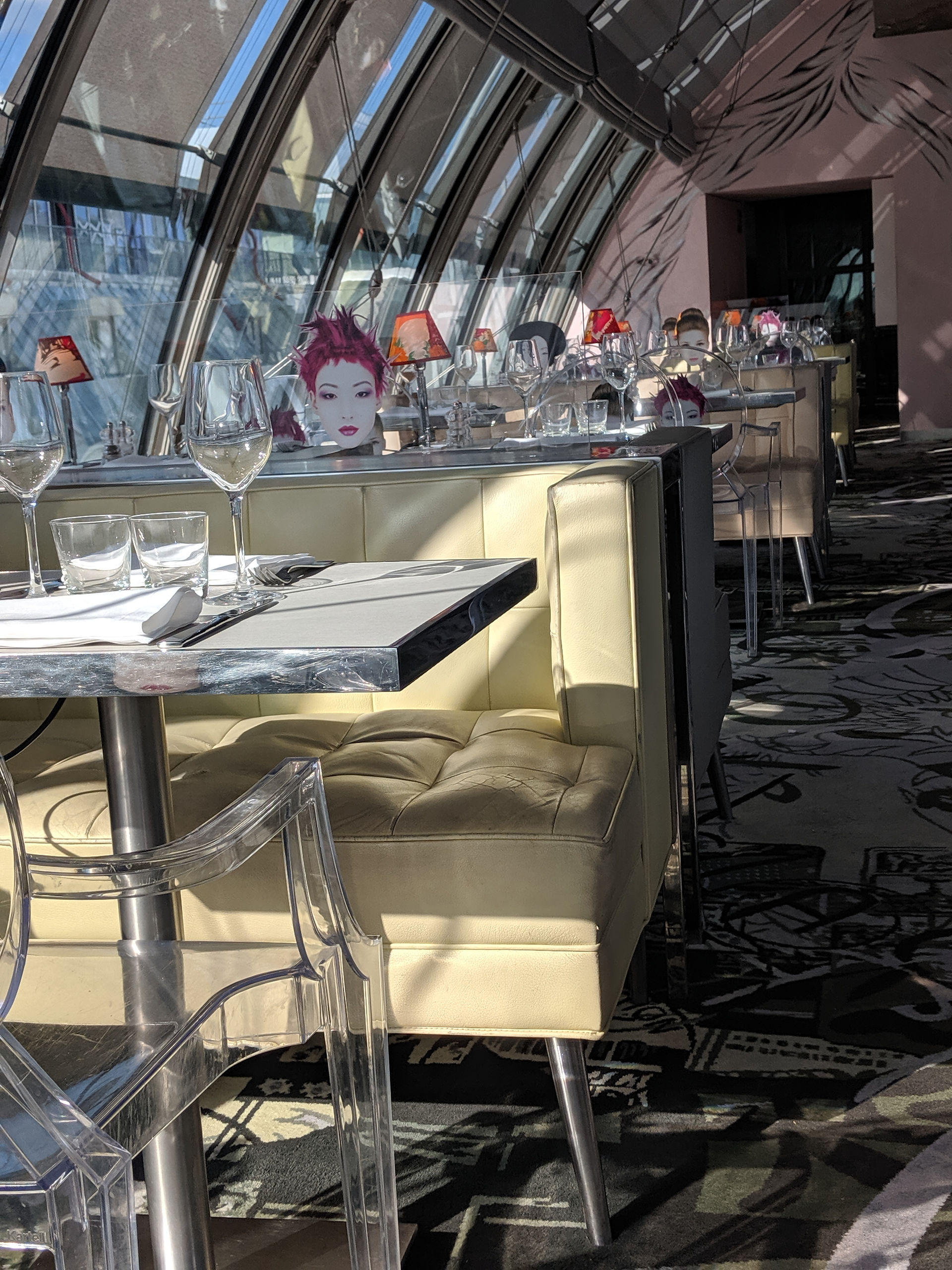 Kong Restaurant in Paris featuring Glass Barrel Ceiling and Lucite Chairs with Faces Printed on The Backs
