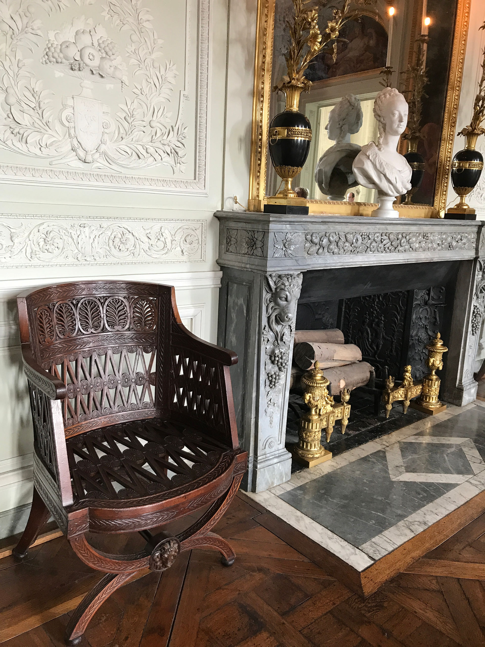 Carved Wooden Armchair next to Fireplace at Versailles