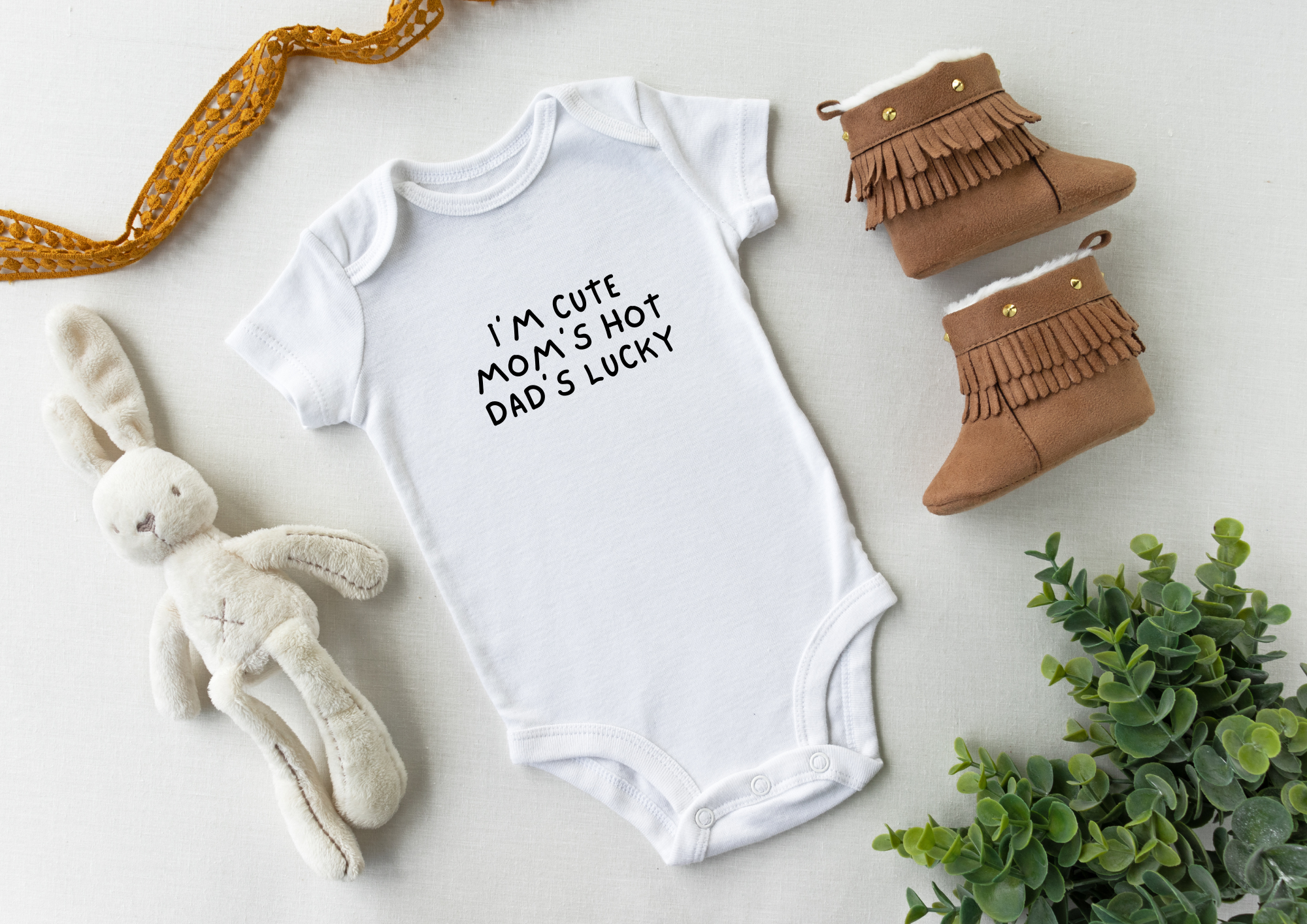 Personalised baby onesie perfect for baby showers intending to be funny with the saying "I'm cute, Mom's Hot, Dad's lucky"
