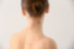 Image of a young woman with many moles on her neck and back
