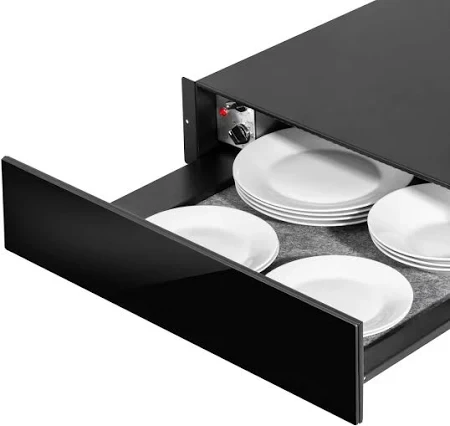 a black drawer filled with white plates and a heater .