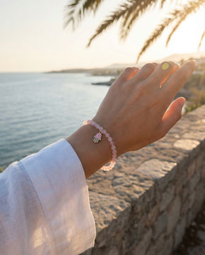 Handmade Onenessliving stone bracelet worn on a woman's wrist, lifestyle jewelry photography in Tarifa.