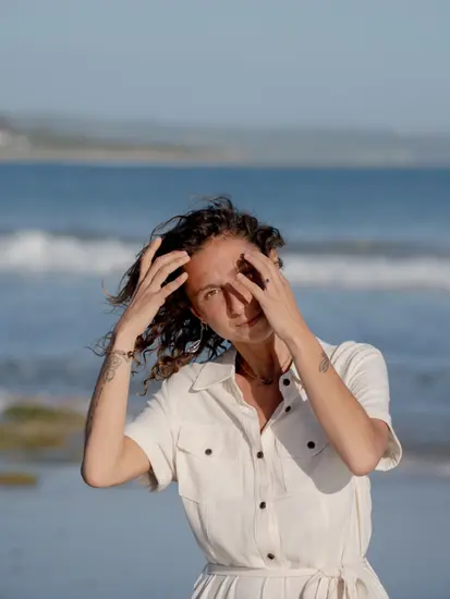 Full-body shot of a model in Red Cocci's denim collection, styled for a casual beach look in Tarifa.