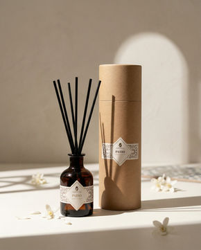 Elegant Onenessliving home fragrance diffuser with wooden reed sticks, lifestyle product photography in a modern Tarifa villa