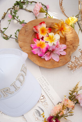 Honeymoon photographer Tarifa - Detail shot of a whimsical selection of flower crowns and delicate veils, perfect for bohemian or wedding-themed photoshoots.