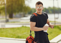 man-standing-by-water-guy-sports-clothes-male-summer-park-with-backpack.jpg