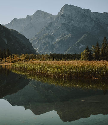 lake-reflecting-mountainous-landscape-surrounded-by-dry-grass-trees.jpg