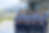 Đội ngũ lao động mặc đồng phục xanh navy đứng trước nhà máy, minh họa dịch vụ nhân lực gia công và hỗ trợ sản xuất.