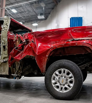 Auto dent repair and metal reshaping on red truck